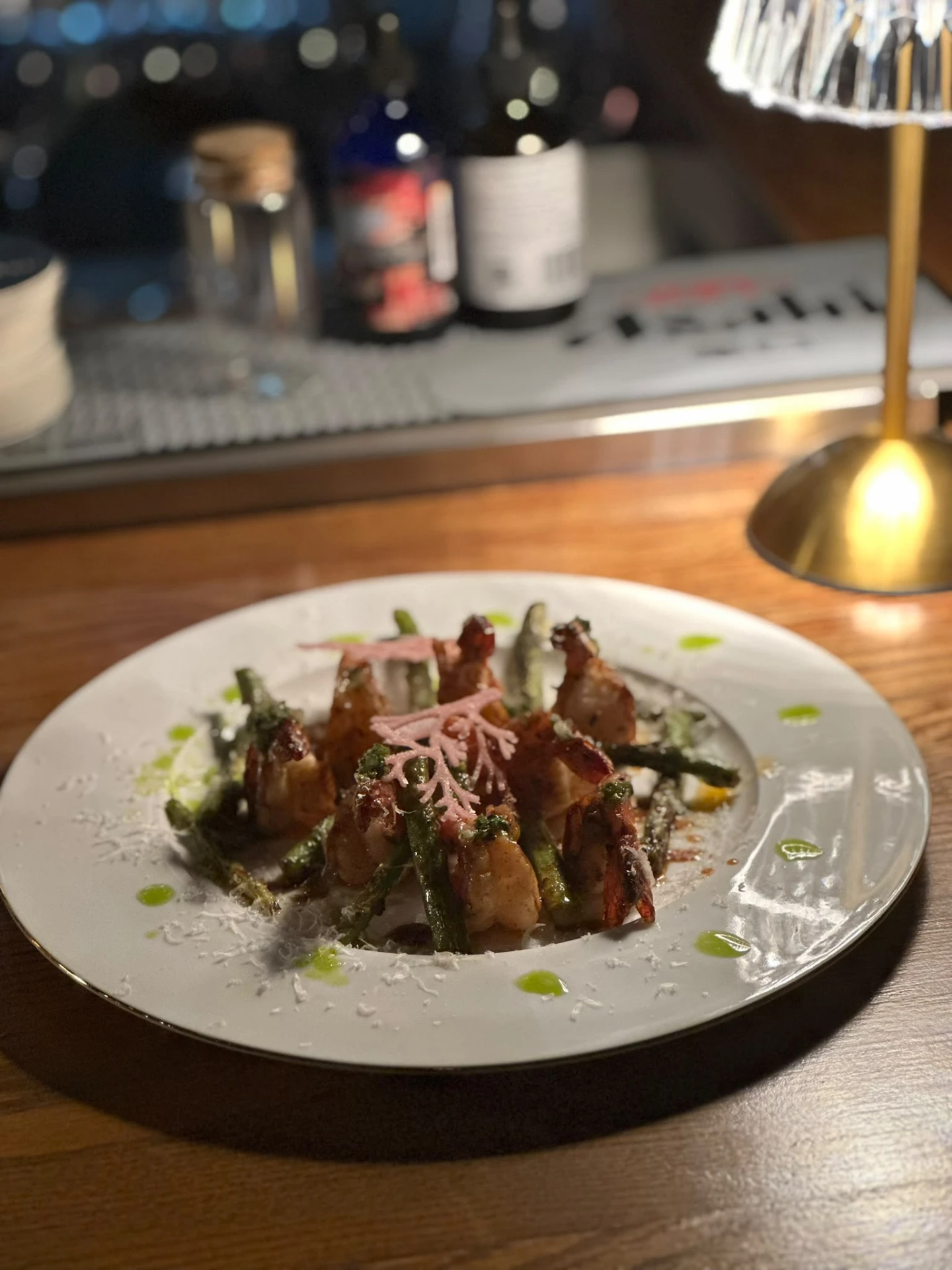 A tasting dish served at the Muse counter beside a golden table lamp